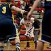 Milan sophomore Latin Davis drives toward the rim against Chelsea defenders on Friday. Milan won 71-40. Daniel Brenner I AnnArbor.com